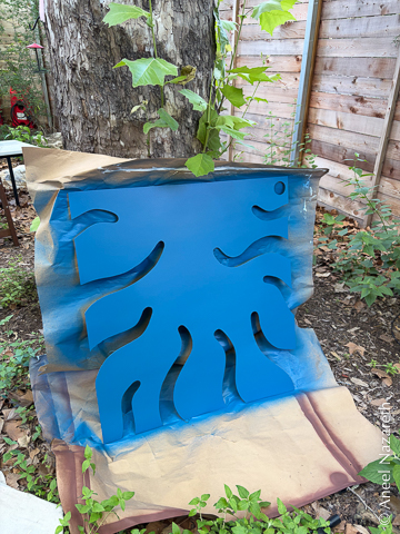 The tentacle panel is up against paper leaning on the tree again. It's blue. There's blue overspray on the paper.